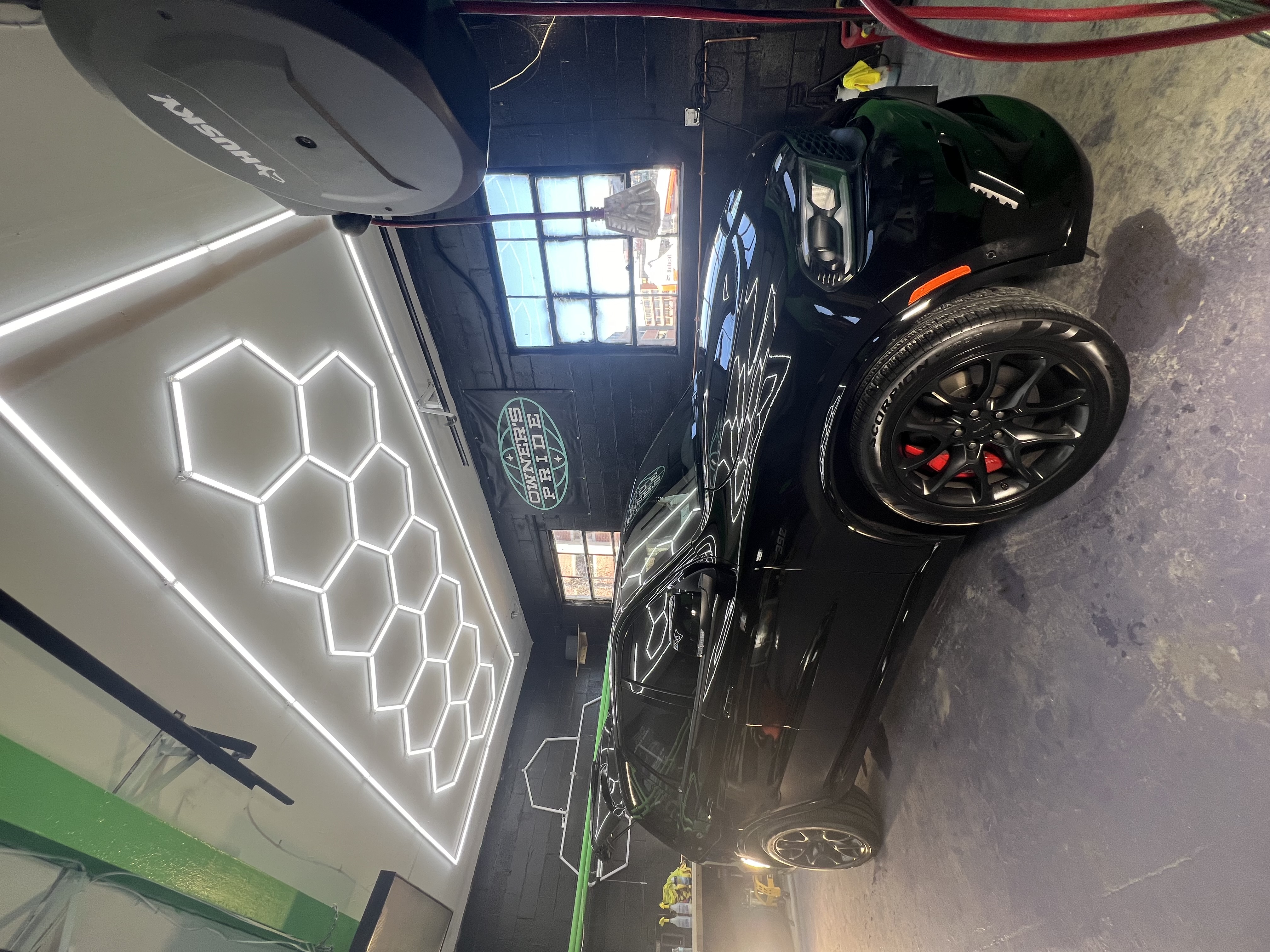 Black Dodge Charger in professional detailing garage
