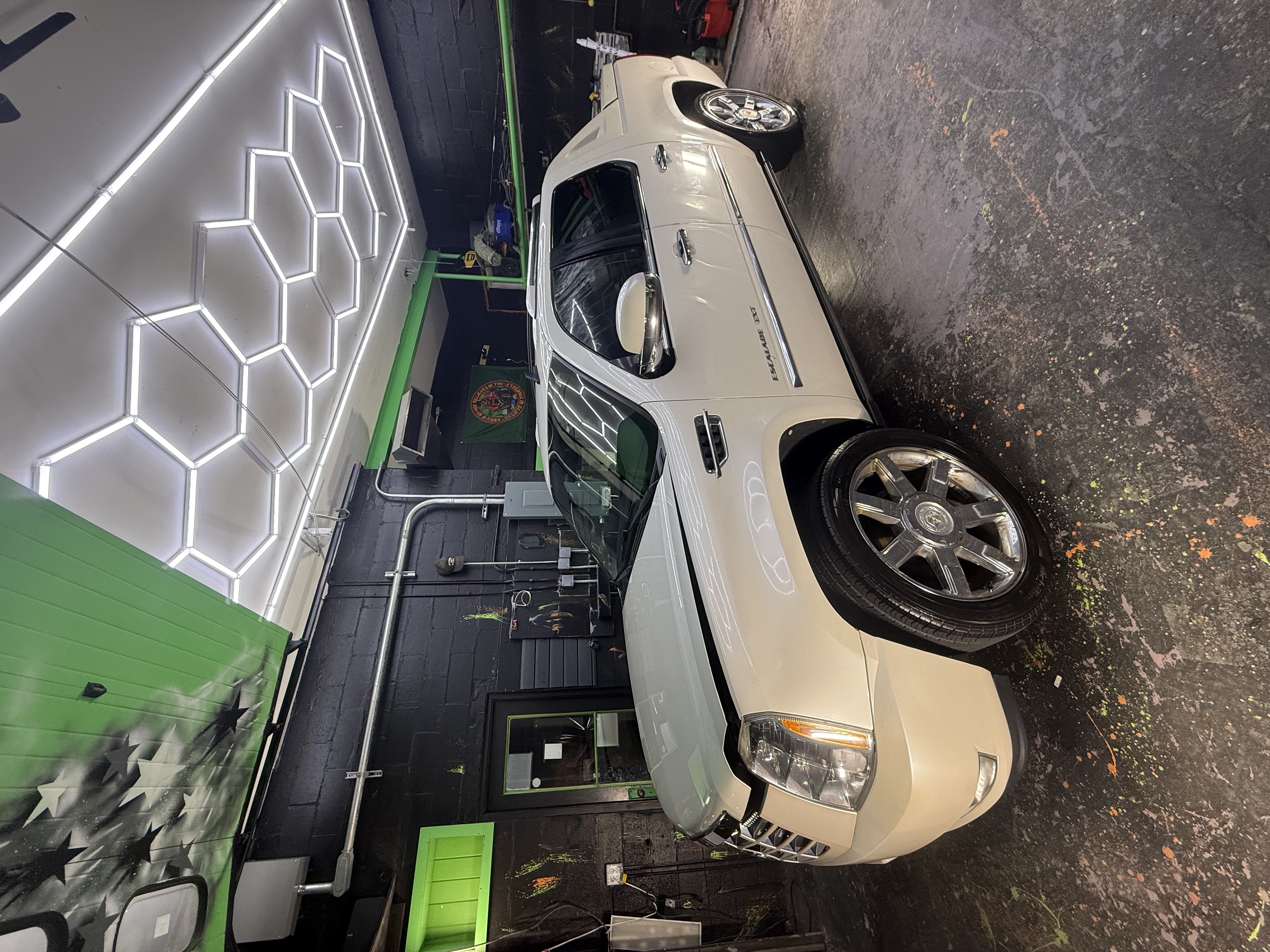 White Cadillac Escalade in professional detailing garage